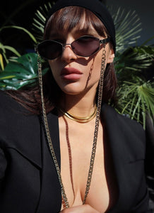 girl wears polygonal black metal frame with black gradient lenses with chain